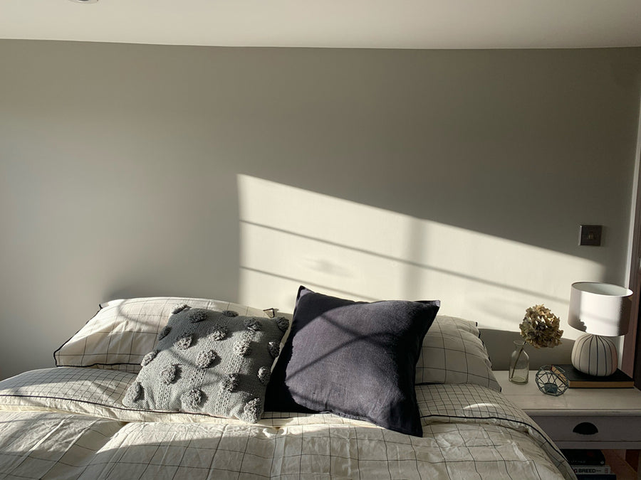 Minimalist bedroom painted in  Lick Greige 02