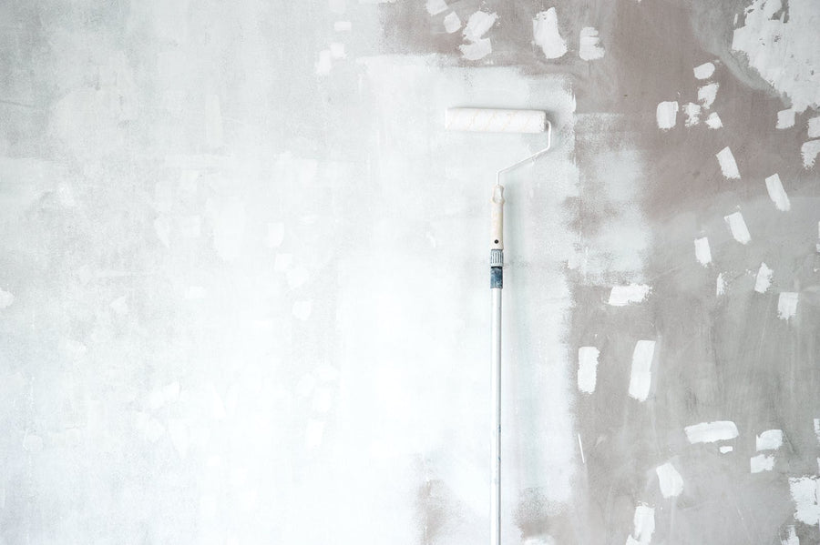 White primer paint being applied to a wall